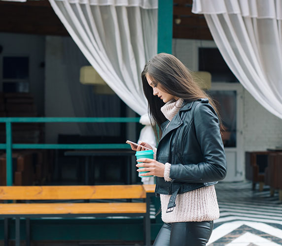 woman-walking-on-the-street-using-app-on-the-phone